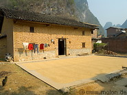 07 Drying rice in front of house