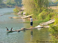 03 Fisherman with cormorant on bamboo boat