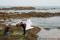 04 Bride on rocks and photographer