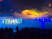 17 Dancers on stage illuminated with blue light