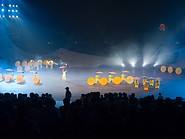 19 Dancers on stage illuminated with blue light