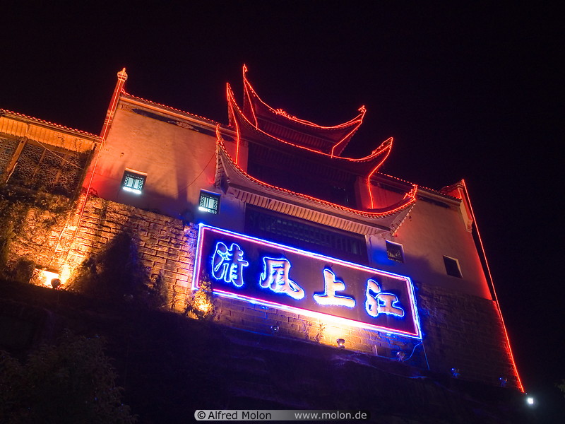 03 Temple facade illuminated with red neon lights at night