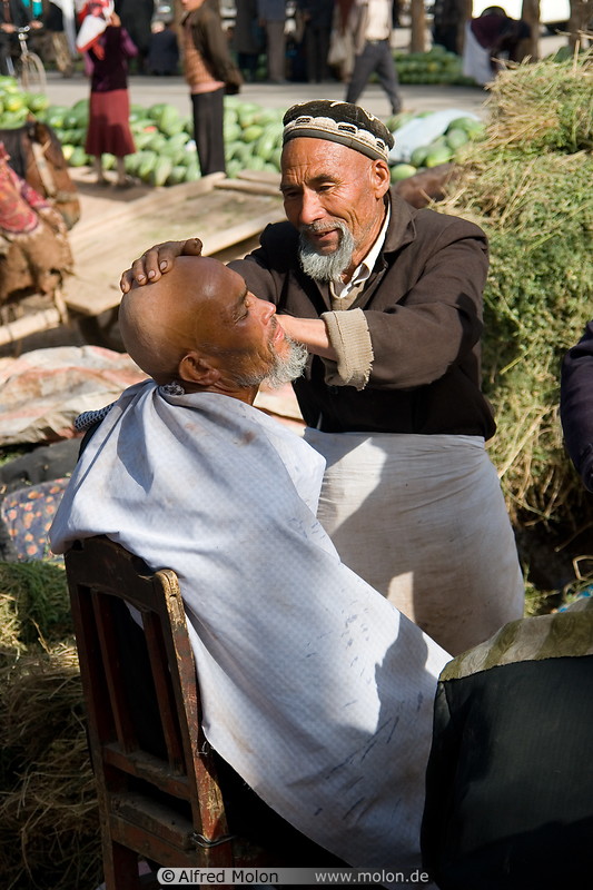 03 Uighur barber shaving customer