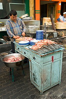 05 Food stall operator preparing skewers
