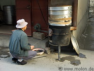 06 Man cooking Chinese buns in steamer