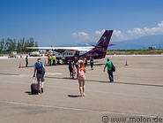18 Tourists walking to the plane