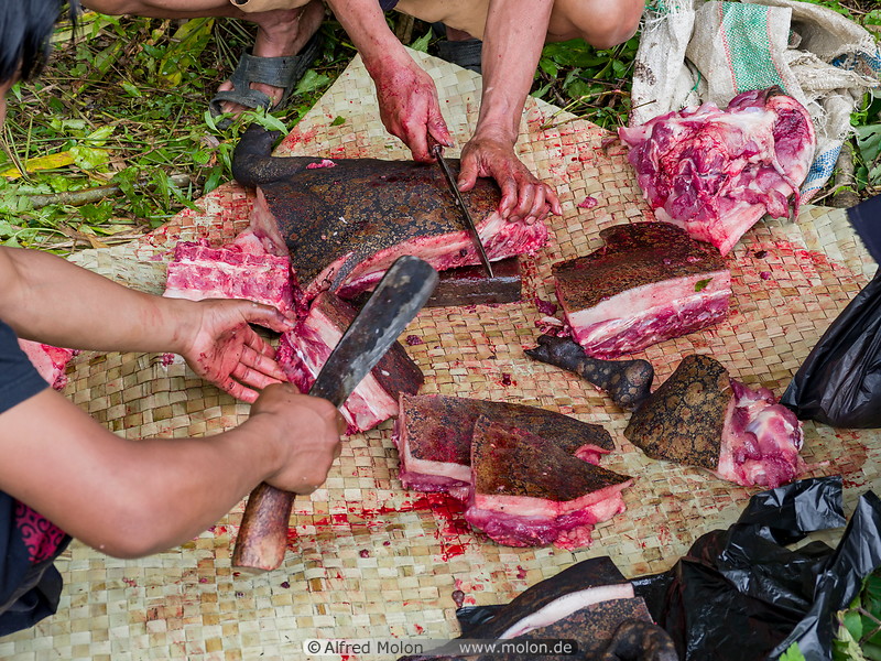 26 Men cutting pig meat