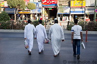 10 Men wearing dishdasha crossing the street