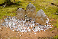 11 Jizo Buddhist images and coins thrown by visitors