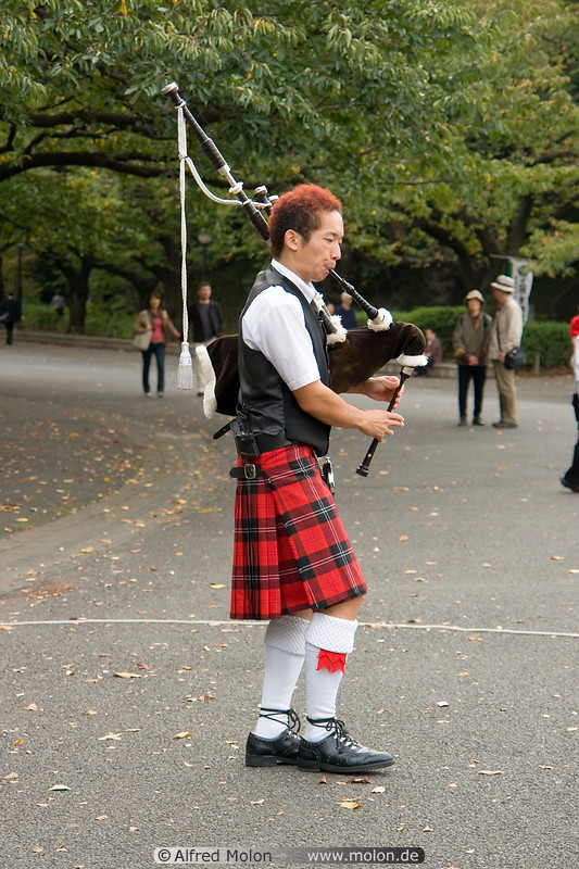 11 Musical performer in Scottish kilt