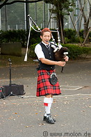 12 Musical performer in Scottish kilt