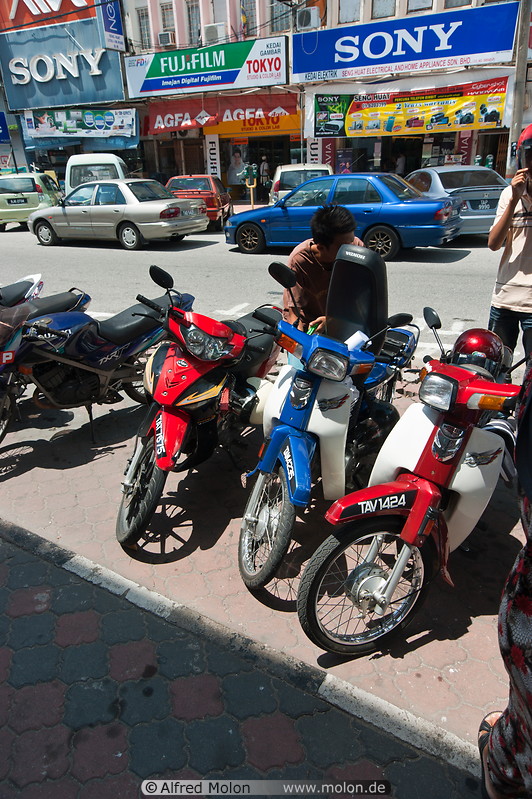 18 Motorbikes parked on pavement