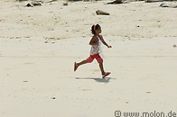 25 Young girl running on beach