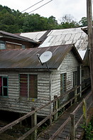 10 Houses with corrugated tin roofs and satellite dish