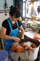 17 Chinese woman preparing chicken rice