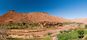 17 Valley with river village and red hills