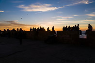 20 Tourists on ramparts at sunset