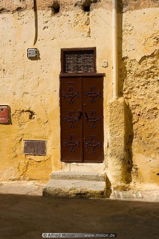 15 Decorated brown door and yellow wall