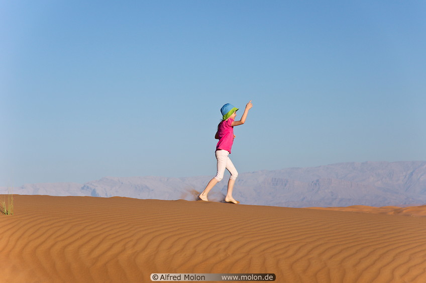 08 Girl running on sand dune