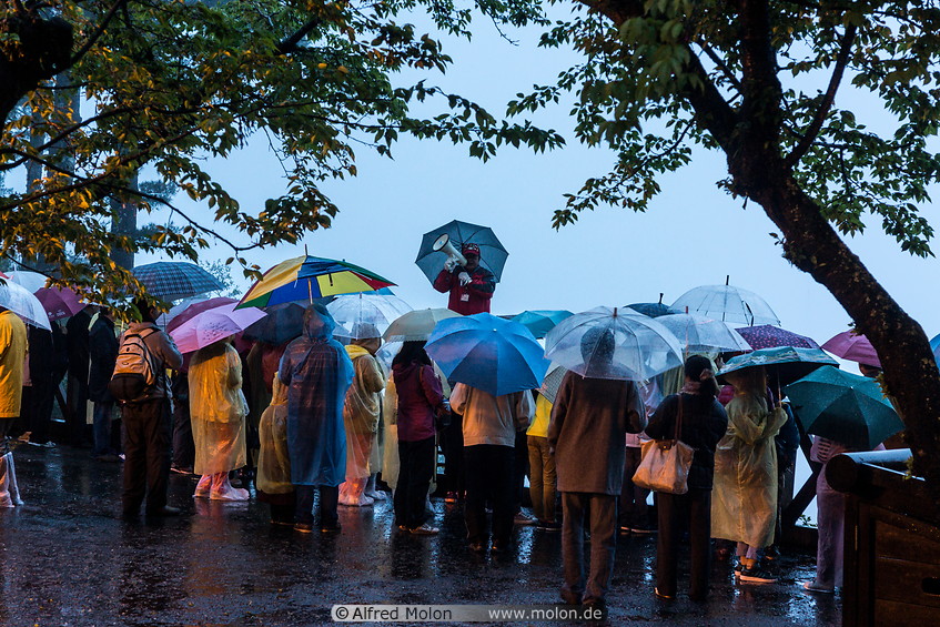 17 Tourists waiting for the sunrise in the rain