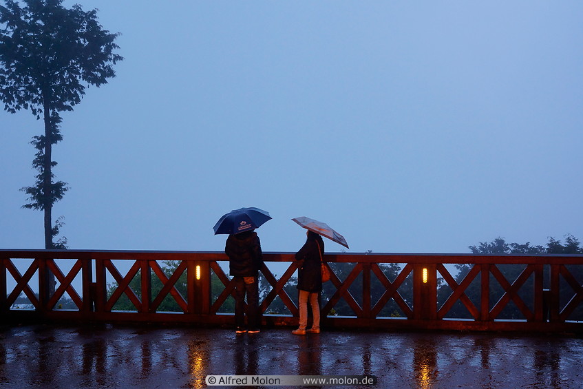 18 Tourists waiting for the sunrise in the rain