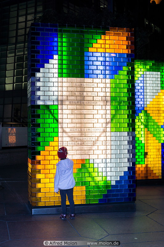 04 Child next to glass monument at night