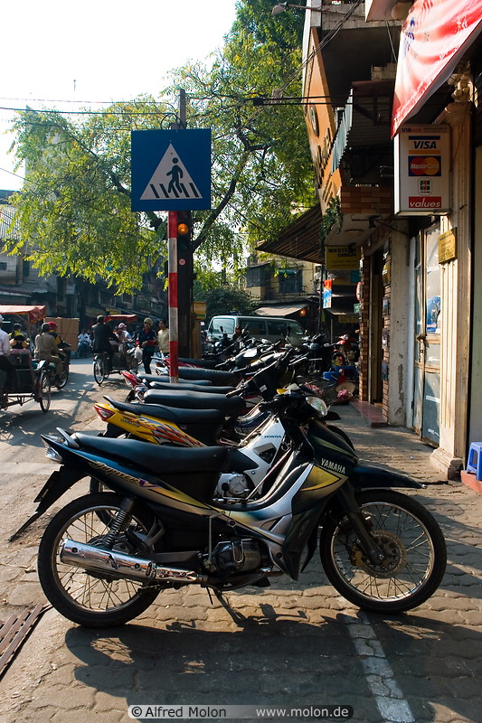 12 Motorbikes parked on pavement