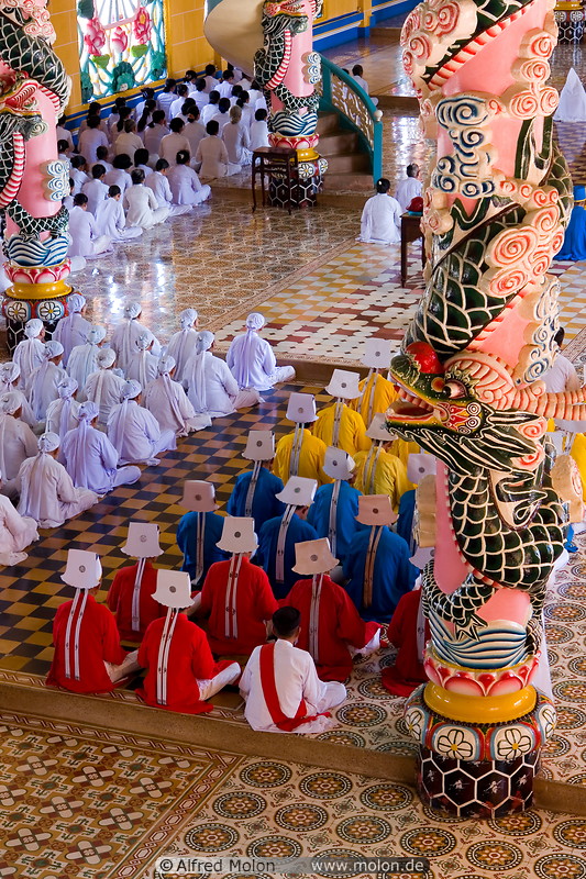 16 Cao Dai priests and ornamental columns